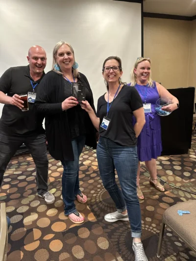 Black Sheep Broker agents celebrating deal success at a real convention event